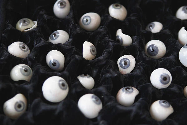 Prosthetic eyeballs are seen in a carrying case during a measuring session for the