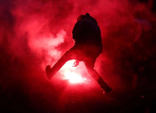 A protester approaches a flare at a protest march during the G7 Summit in Quebec City