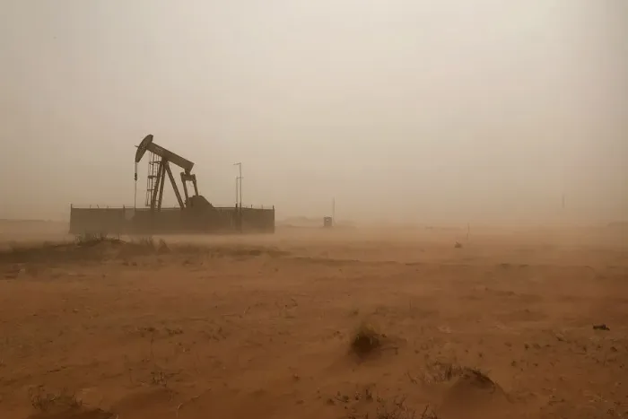 Framed Print : A pump jack lifts oil out of a well during a sandstorm in Midland