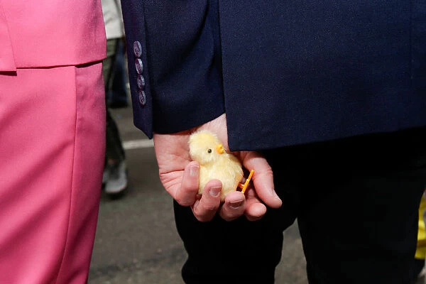 A puppet chick is seen in the hand of a participant at the annual Easter Parade