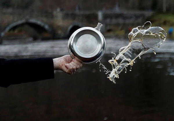 A Quaich of whisky is thrown in the river to bless the river on the opening day of the