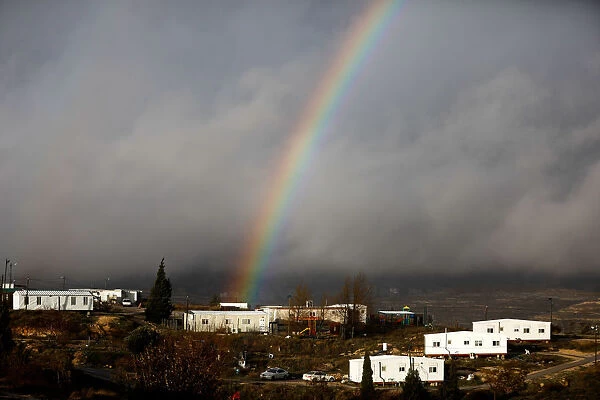 A rainbow is seen over the Israeli settler outpost of Amona in the occupied West Bank