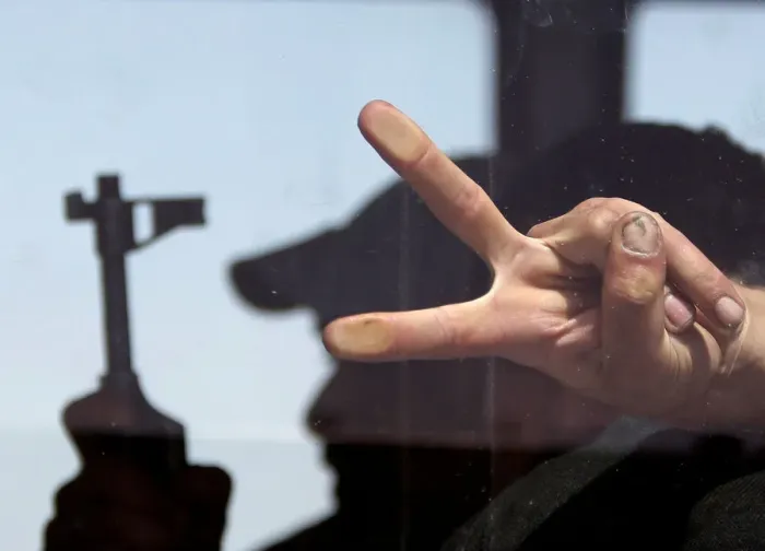 Framed Print : A rebel fighter gestures as he sits inside a bus during evacuation Framed Print : A rebel fighter gestures as he sits inside a bus during evacuation