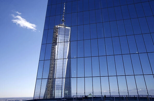 Reflection of the One World Trade Center tower is seen from a terrace on the 57th