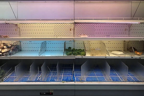 An empty refrigerator is seen at a supermarket in Caracas