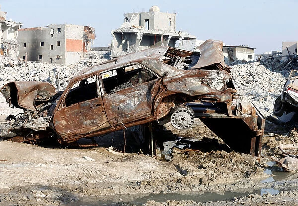Remains of a car and buildings are seen following a security campaign against Shi ite