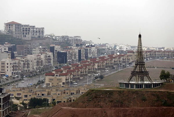 A replica of the Eiffel Tower is seen on a hill in an area being developed in Bahria Town
