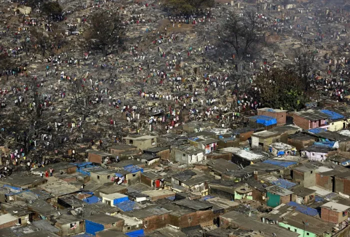 Framed Print : Residents attempt to salvage belongings from gutted hutments in a slum area in Mumbai