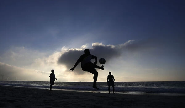 Residents play soccer at Copacabana beach in Rio de Janeiro