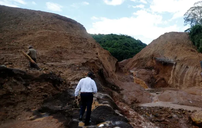 Framed Print : Residents tour the dam that burst its walls, overrunning nearby homes Framed Print : Residents tour the dam that burst its walls, overrunning nearby homes