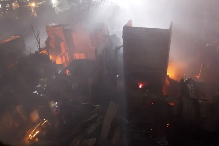 Framed Print : Residents walk with flashlights as they return to their burned homes during a fire in Framed Print : Residents walk with flashlights as they return to their burned homes during a fire in