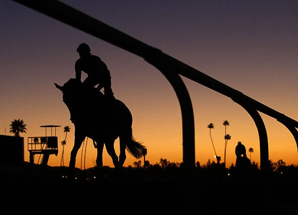 Riders take part in workout at dawn for the Breeders Cup horse race at Santa Anita