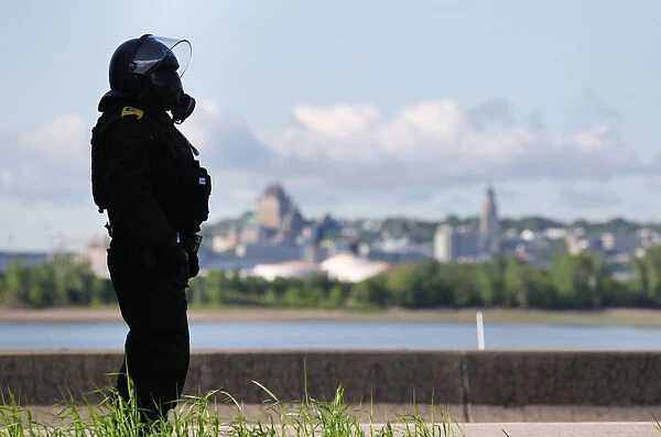 A riot police officer stands guard before the start of the G7 Summit in Quebec City