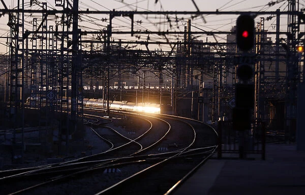 The rising sun reflects on a departing train during a 24-hour nationwide train strike