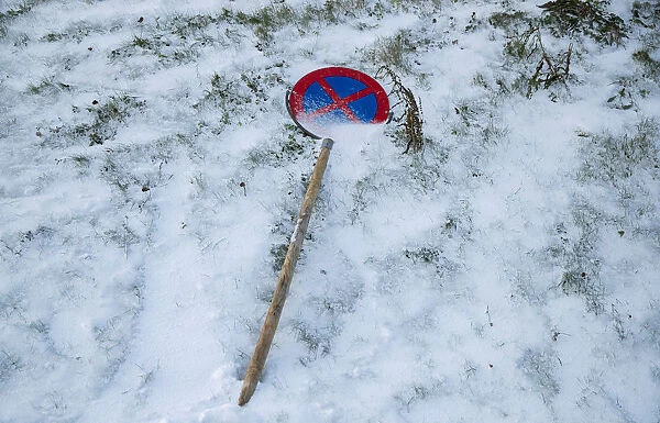 A road sign lies on the grass in Kirkenes