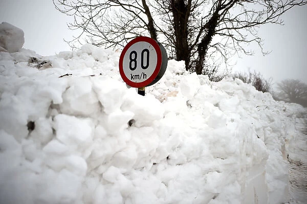 A road sign is seen submerged in deep snow in Kilteel
