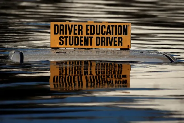 Framed Print : The roof a student driver car is pictured partly underwater as a result of Hurricane