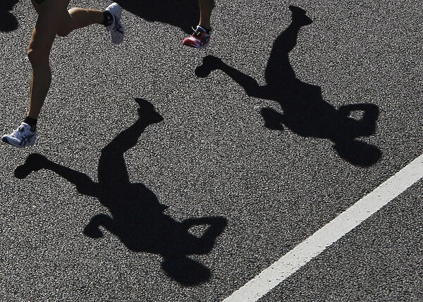 Runners cast their shadows during the 2008 Tokyo Marathon