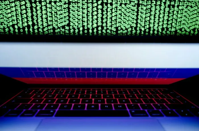 Framed Print : Russian flag is seen on the laptop screen in front of a computer screen on which cyber Framed Print : Russian flag is seen on the laptop screen in front of a computer screen on which cyber