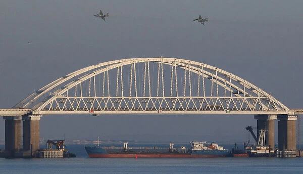 Russian jet fighters fly over a bridge connecting the Russian mainland with the Crimean