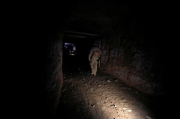 Russian soldier walks inside a tunnel that was used by rebels in Jobar, eastern Ghouta