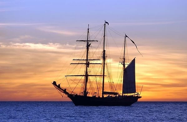 Sail training barquentine ship Leeuwin sails in the Indian Ocean at sunset off the