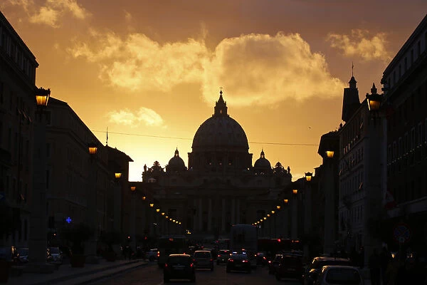 Saint Peters Basilica at the Vatican is silhouetted during sunset in Rome
