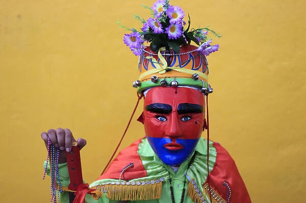 A Salvadoran dancer known as Historiante poses for a photo during a religious festival