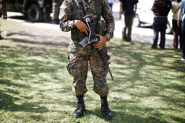 Salvadorean army soldier holds his rifle during a patrol in San Salvador, El Salvador