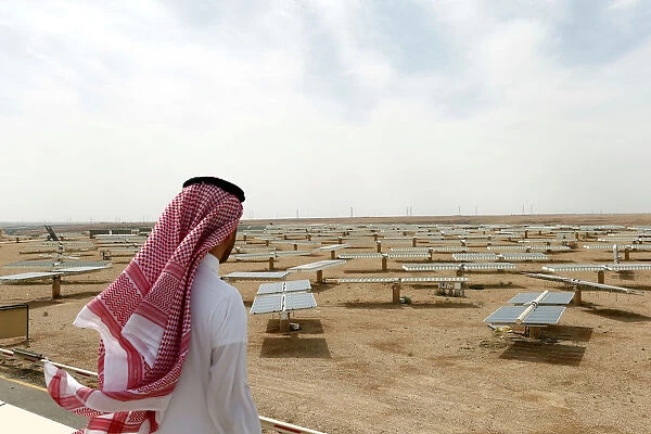 Saudi man looks at the solar plant in Uyayna, north of Riyadh
