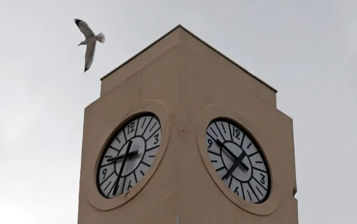 Framed Print : A seagull flies past a broken tower clock which does not indicate the correct time in Framed Print : A seagull flies past a broken tower clock which does not indicate the correct time in