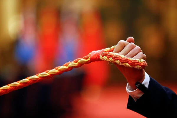A security agent holds a rope before reporters as Chinese President Xi Jinping meets