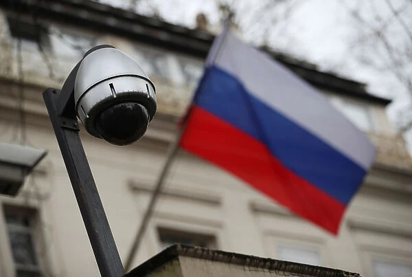A security camera is seen, and a flag flies outside the consular section of Russia s
