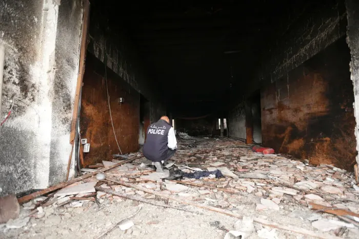 Framed Print : Security personnel inspects the site of a suicide attack on the electoral commission in Framed Print : Security personnel inspects the site of a suicide attack on the electoral commission in