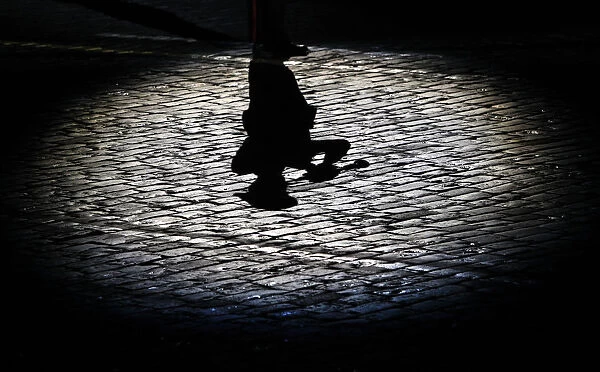 The shadow of a participant is cast onto the ground during the International Military