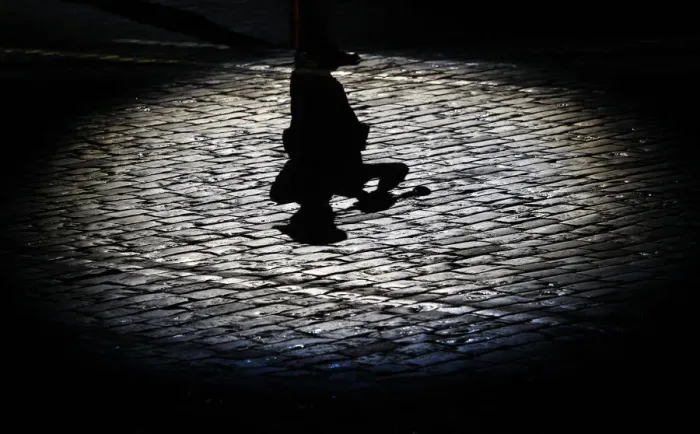 Framed Print : The shadow of a participant is cast onto the ground during the International Military