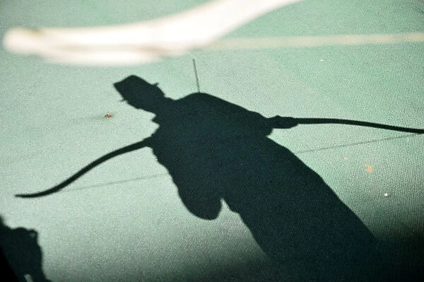 The shadow of a participant is pictured as he takes part in an archery event