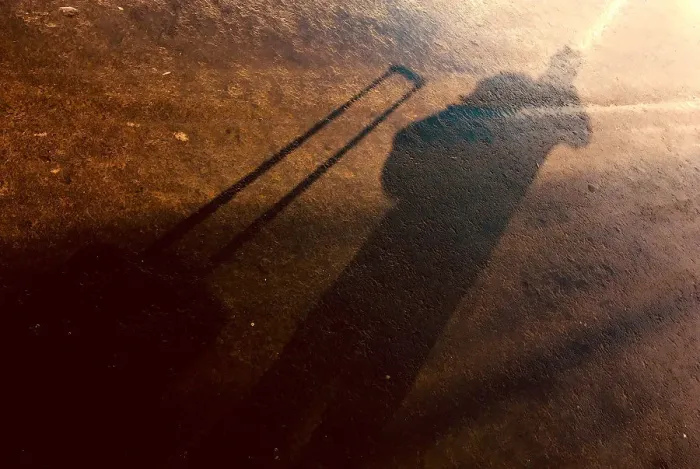 Framed Print : The shadow of a photographer and his equipment bag can be seen on a footpath after a storm at Samara Stadium Framed Print : The shadow of a photographer and his equipment bag can be seen on a footpath after a storm at Samara Stadium