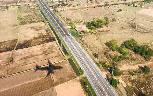 A shadow of a plane is seen near a highway road before landing at Roi Et airport