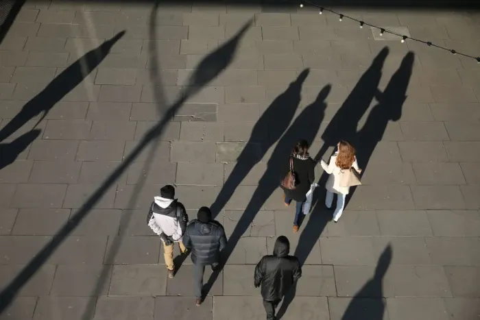 Framed Print : The shadows of pedestrians are cast on the pavement as they walk along the South Bank in Framed Print : The shadows of pedestrians are cast on the pavement as they walk along the South Bank in