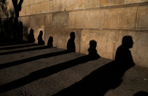 Shadows of people queuing to vote are cast on a wall during voting in Catalonia s