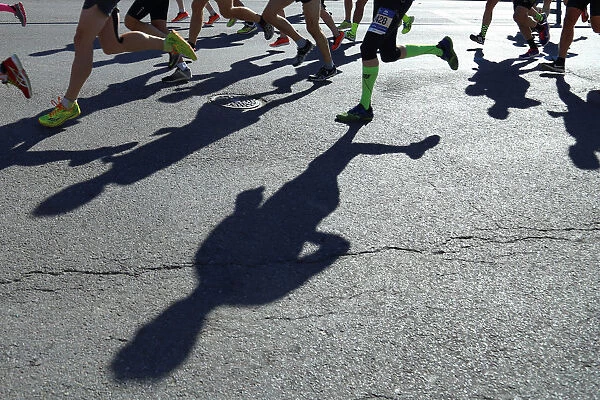 Shadows of runners hit the ground during New York City Marathon in New York