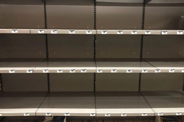 Empty shelves for headlights, lanterns and other supplies are seen at a Home Depot store