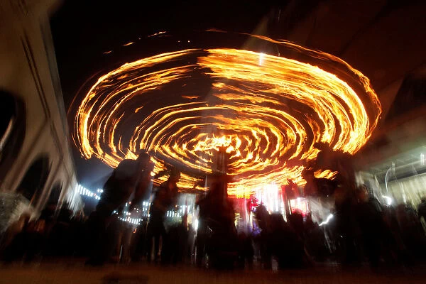 Shi ite Muslims perform with fire during commemorations for Ashoura in Najaf