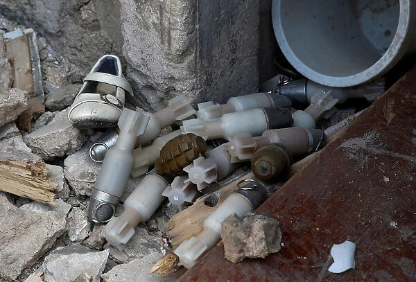 A shoe is seen among a pile of unexploded ordnance at the positions of the Iraqi forces