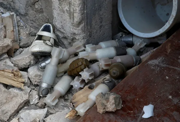 Framed Print : A shoe is seen among a pile of unexploded ordnance at the positions of the Iraqi forces Framed Print : A shoe is seen among a pile of unexploded ordnance at the positions of the Iraqi forces