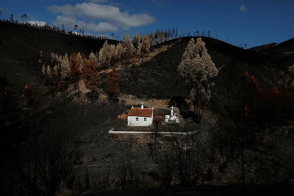 A shrine is seen after a forest fire near the village of Serta