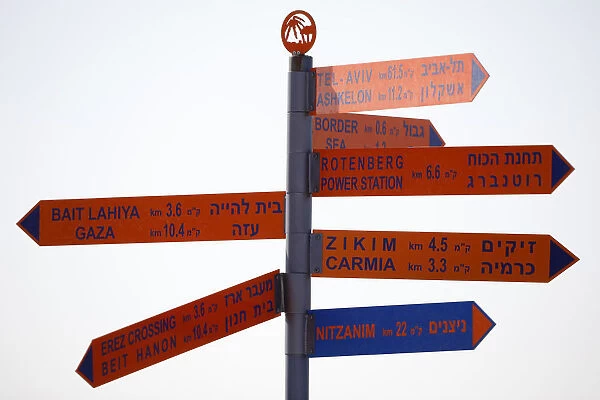 A sign displays distances to various cities and sites in Israel and the Gaza Strip