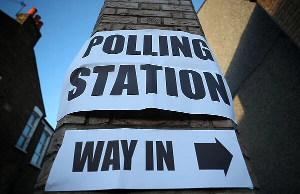 Signage is seen outside a polling station as voting begins in local government elections