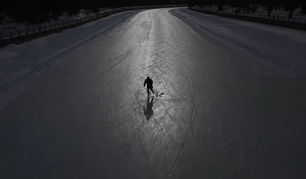 A skater casts a shadow on the Rideau Canal in Ottawa